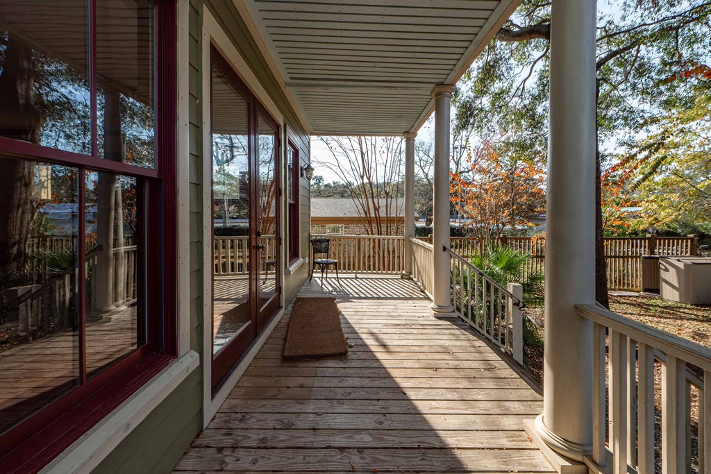 A wooden deck with a bench and railings.
