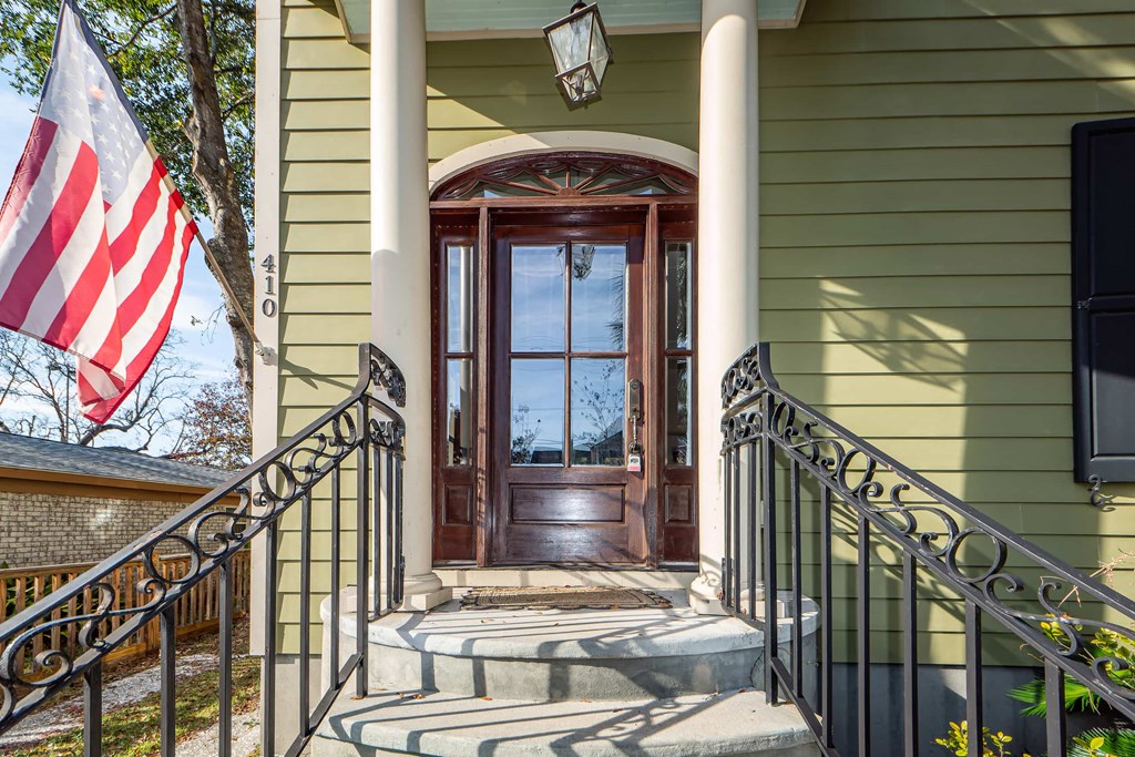 A house with a wooden door and a flag on the left.