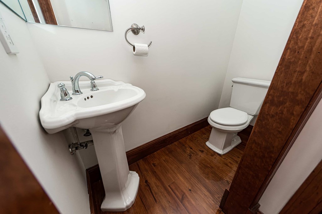 A white sink and toilet in a small bathroom.
