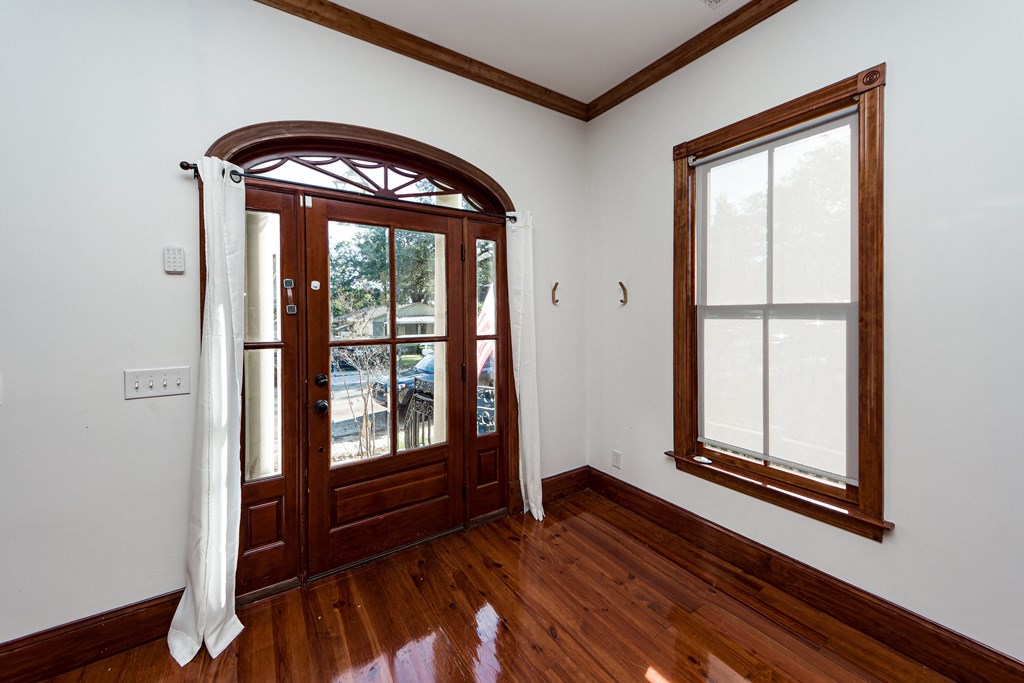 A room with a wooden floor and a window.
