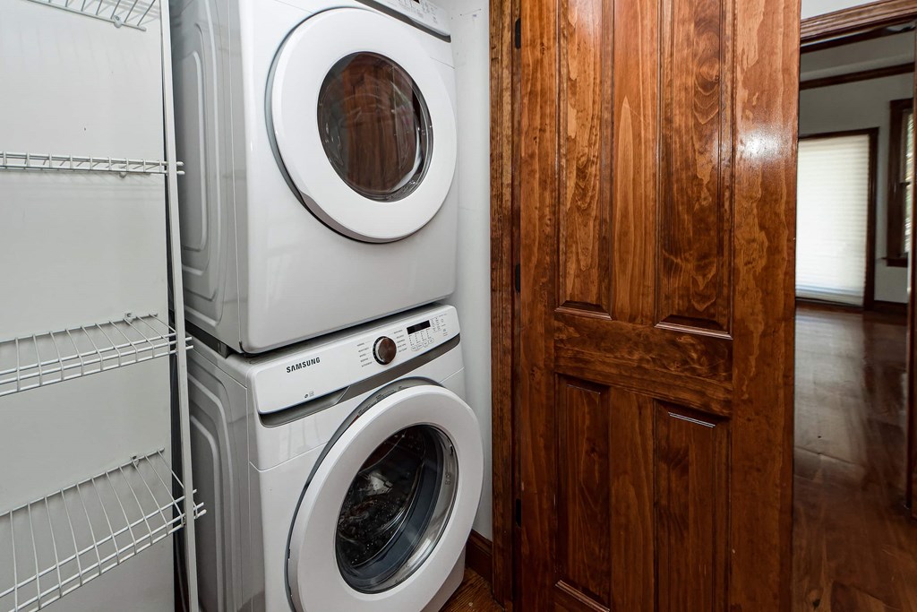 A stack of white washing machines in a laundry room.