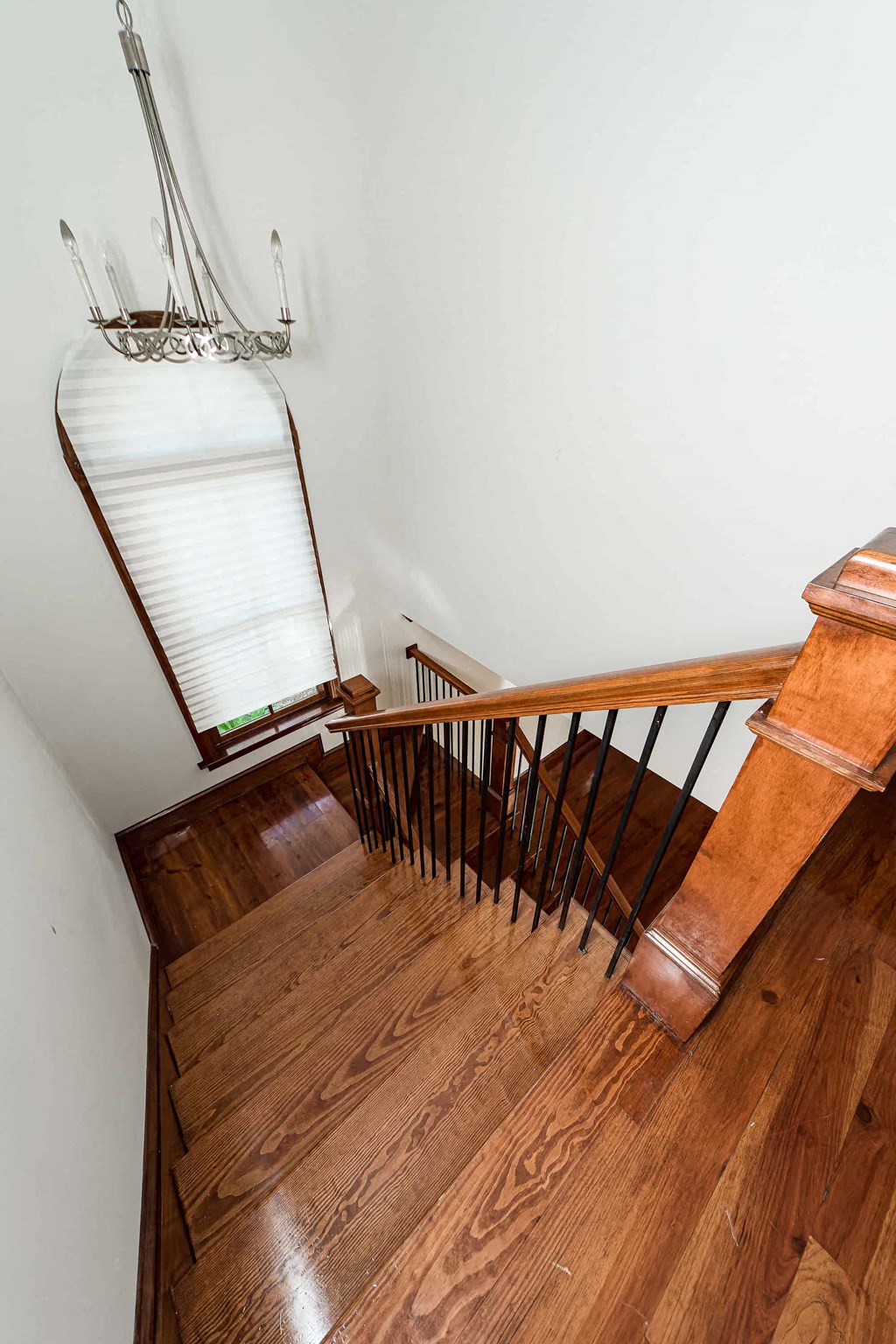 A staircase with a white railing and wooden steps.