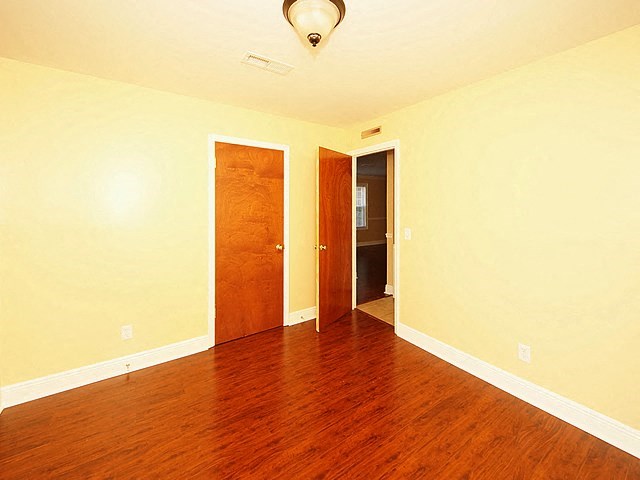 a empty room with a wood floor and a door