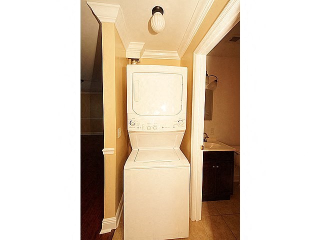 a bathroom with a toilet and a washing machine in it