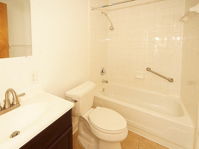a bathroom with a toilet and a tub and a sink