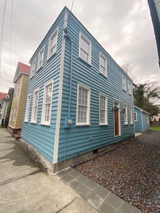 a blue house on the side of a street