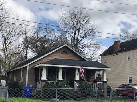 A house with a flag on the front porch.