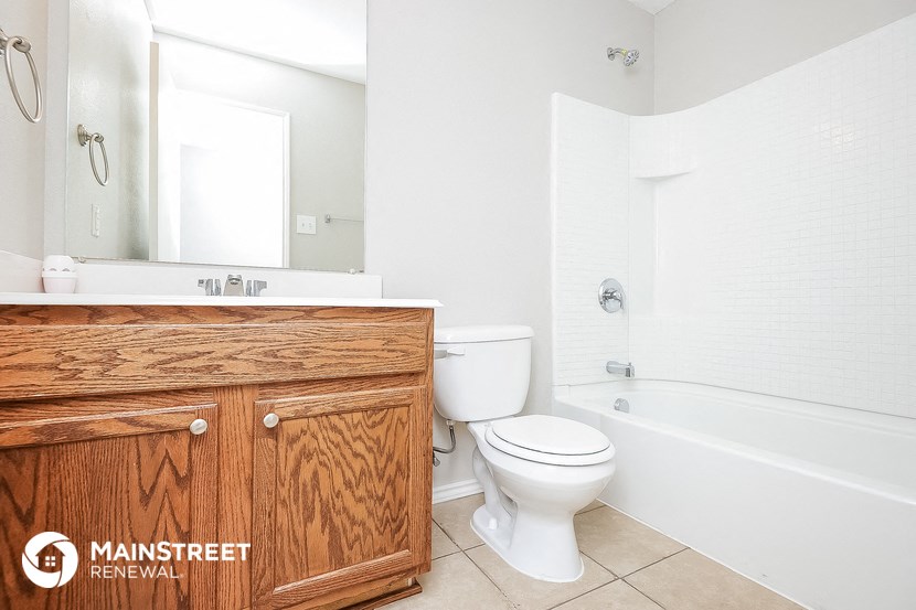 a bathroom with a toilet and a sink and a bath tub