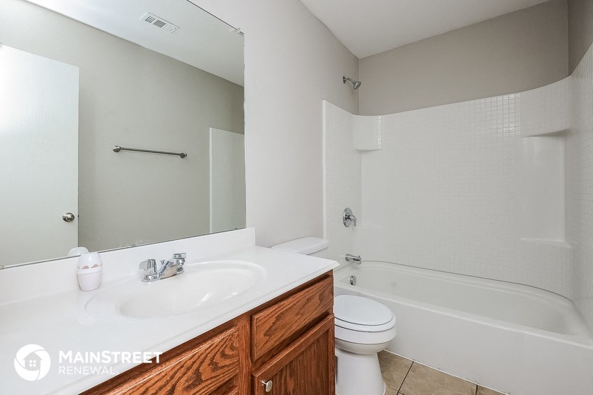 a bathroom with a white sink and a tub and a toilet