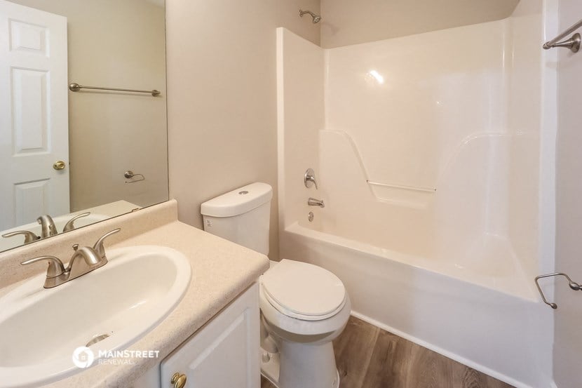 a bathroom with a sink toilet and a bath tub