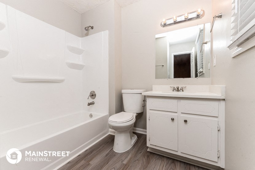 a bathroom with a sink toilet and a bath tub