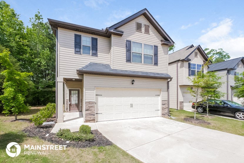 a white house with a white garage door