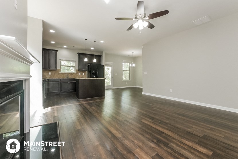 the living room and kitchen of a new home