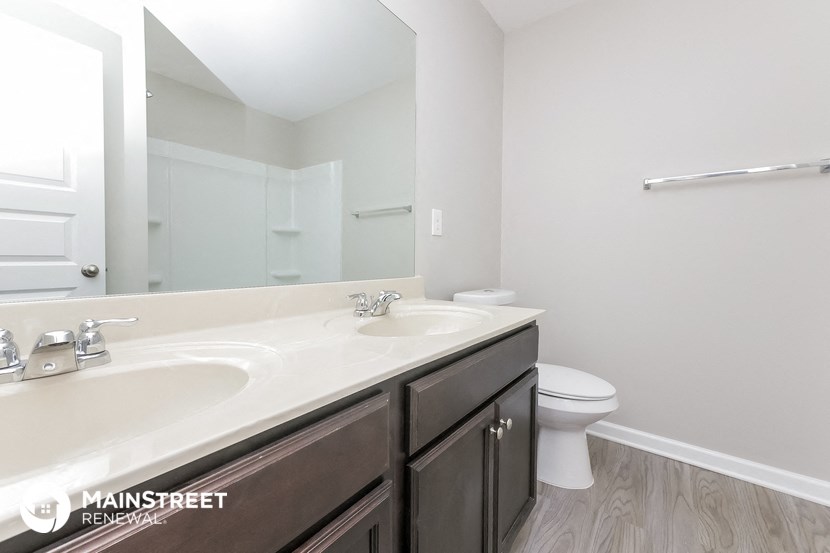 a bathroom with a sink and a toilet and a mirror