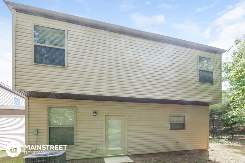 the exterior of a small house with wood siding