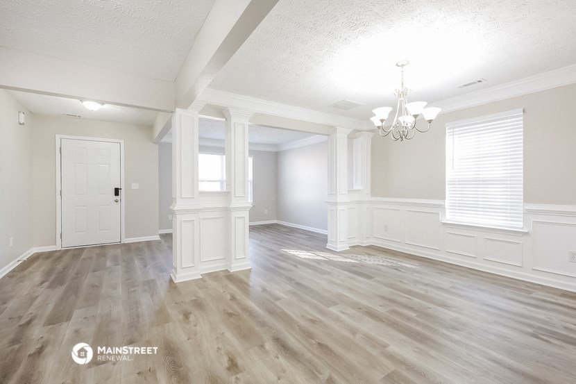 the living room and dining room with hardwood flooring