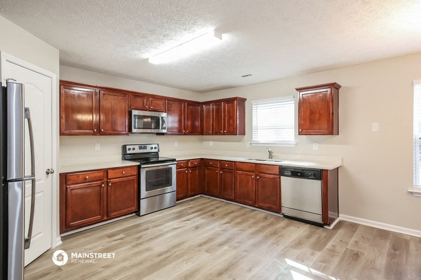a kitchen with wooden cabinets and stainless steel appliances