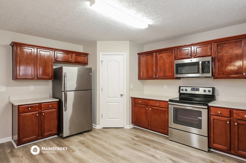 the kitchen of our studio apartment atrium with stainless steel appliances and wooden cabinets