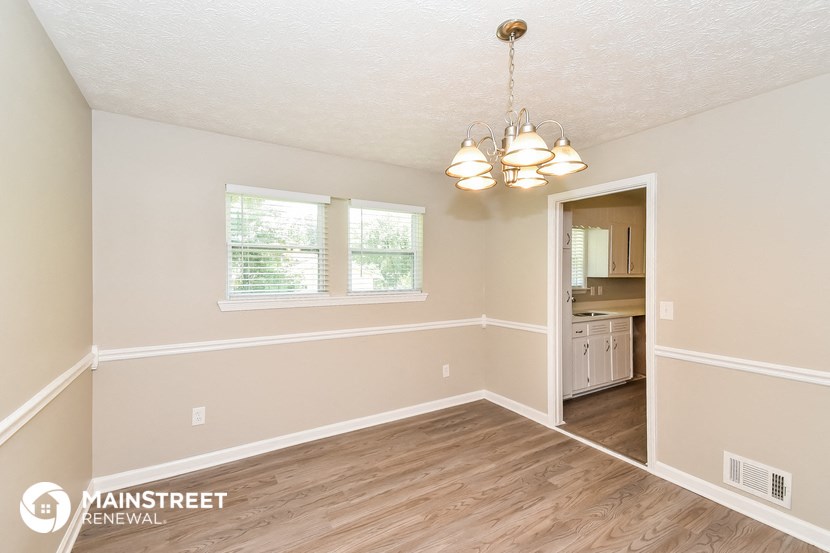 the spacious living room and dining room with hardwood flooring
