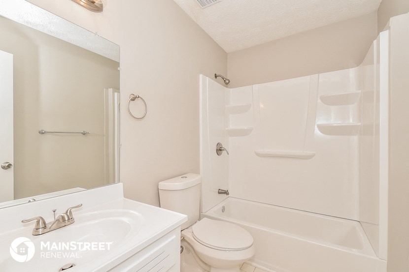 a bathroom with a sink toilet and a shower