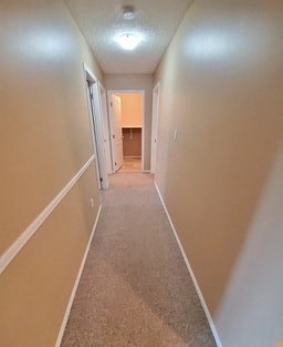 a long hallway with white walls and a white door