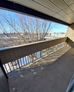 a balcony with a view of a city and a river
