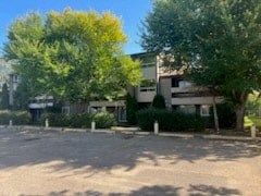 an empty parking lot in front of an apartment building