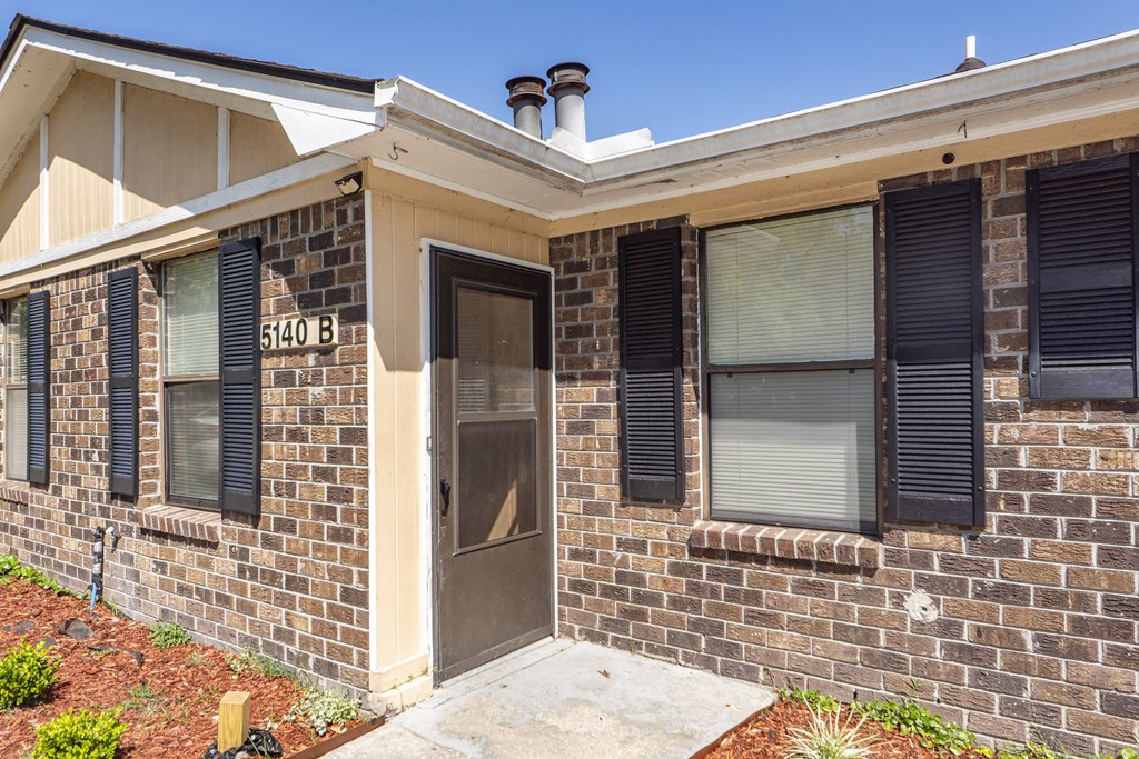 a small brick building with a front door