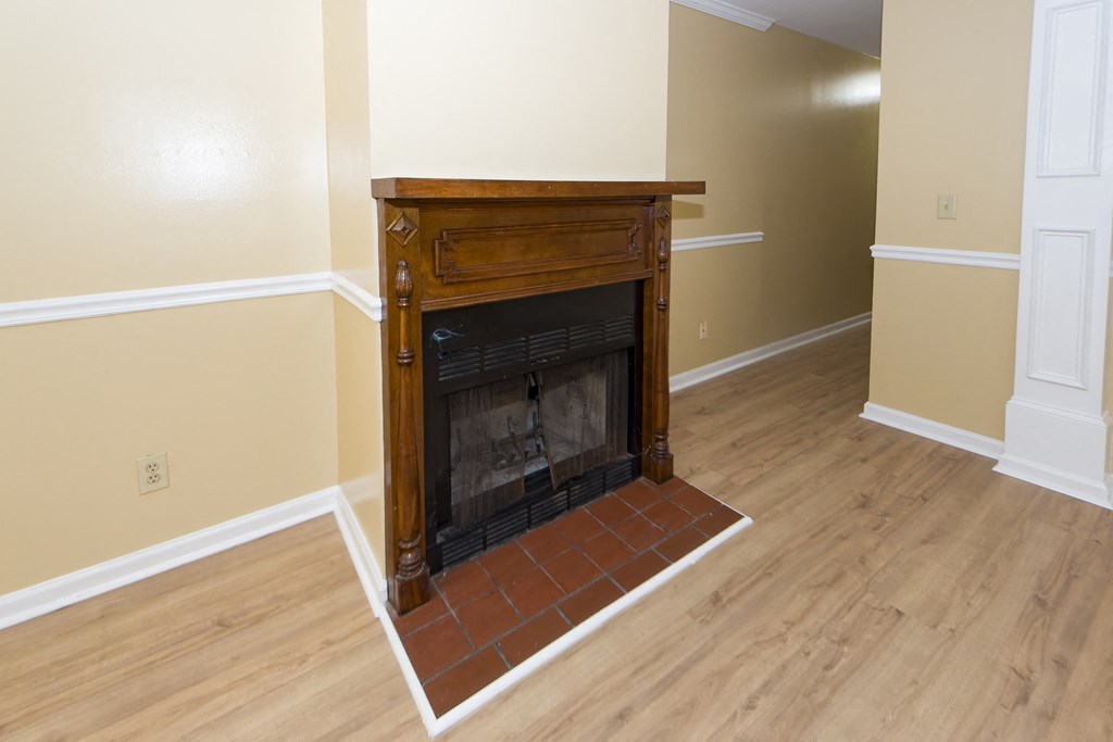 a living room with a fireplace and a wooden floor