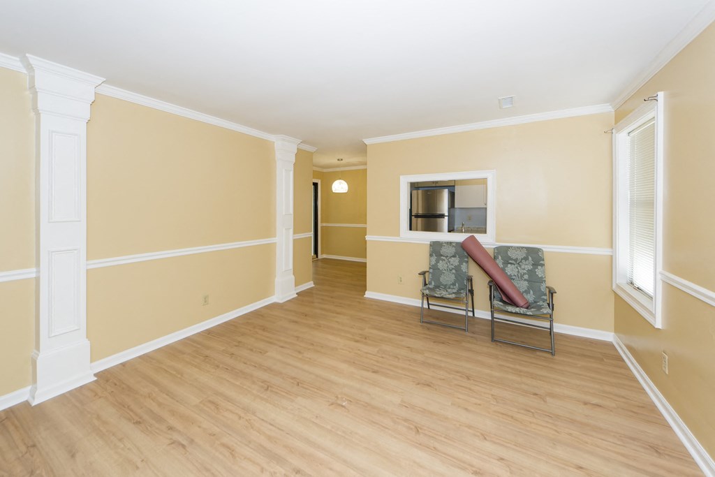 a living room with yellow walls and a hardwood floor    and a