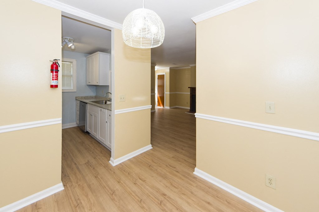 a view of a living room and kitchen from the dining room
