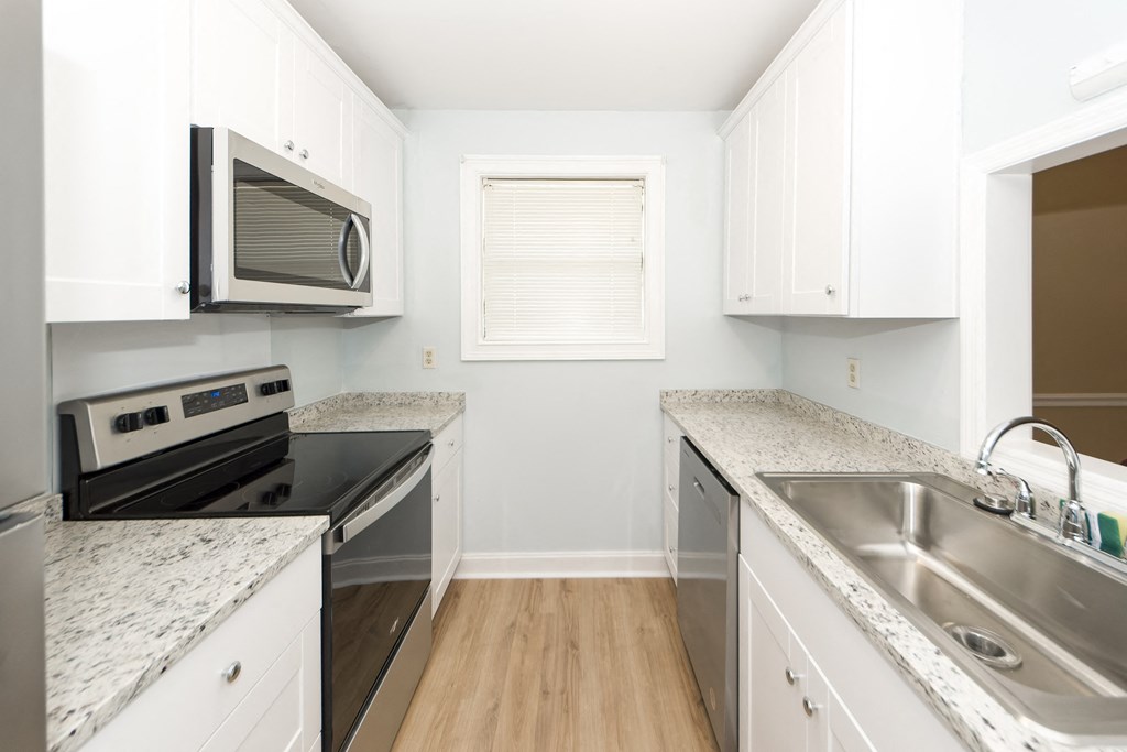 a kitchen with granite counter tops and stainless steel appliances