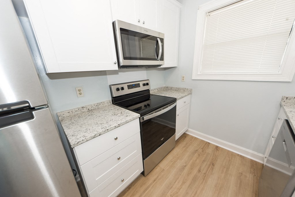 a kitchen with stainless steel appliances and a microwave
