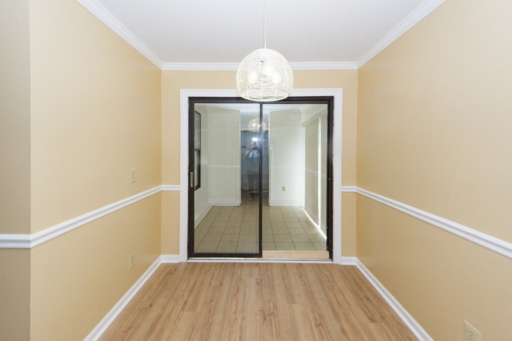 a view of a hallway with a mirror and a chandelier