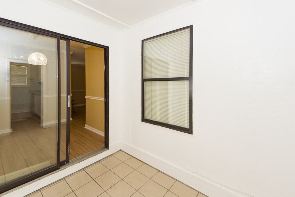 a living room with a window and a door to a bathroom