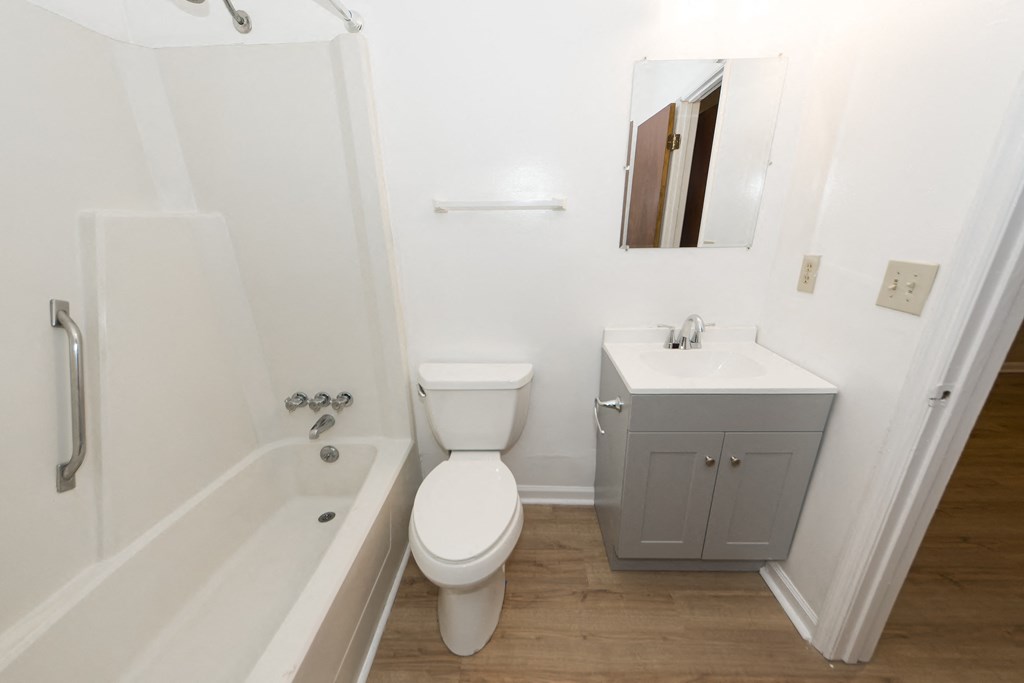 a small bathroom with a sink toilet and bath tub