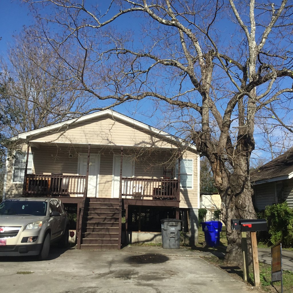 A house with a tree in front of it.