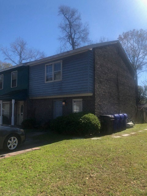A house with a blue car parked in front.