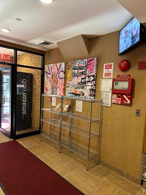 the lobby of a building with a display of posters on the wall