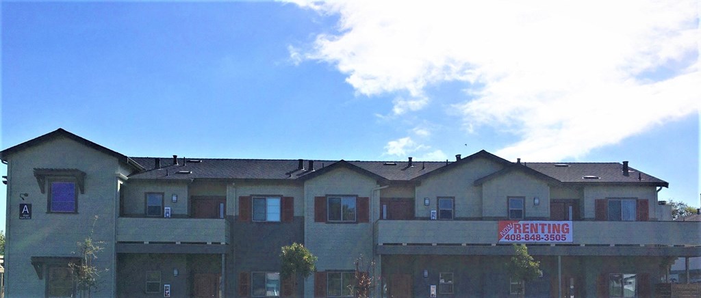 the roof of an apartment building with a sign for renting apartments