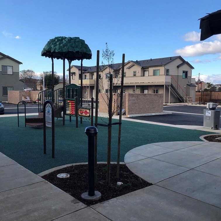 a playground with a swing set in a park