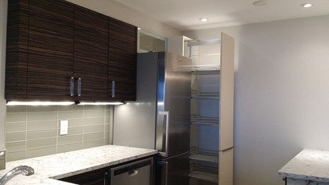 a kitchen with a stainless steel refrigerator and a counter top