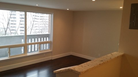 a living room with a large window and a table