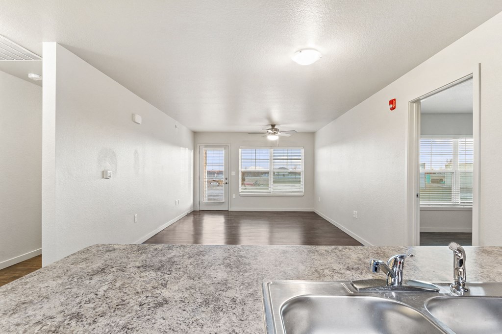 an empty kitchen with a sink and a window