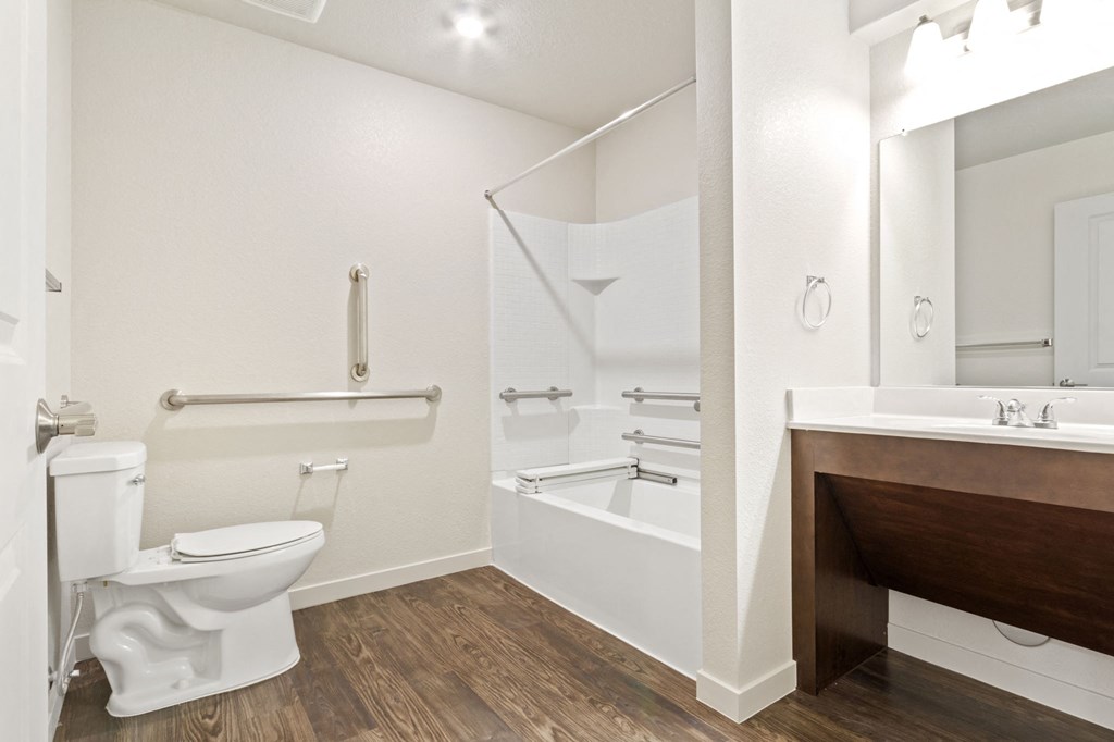 a bathroom with a toilet and a tub and a sink