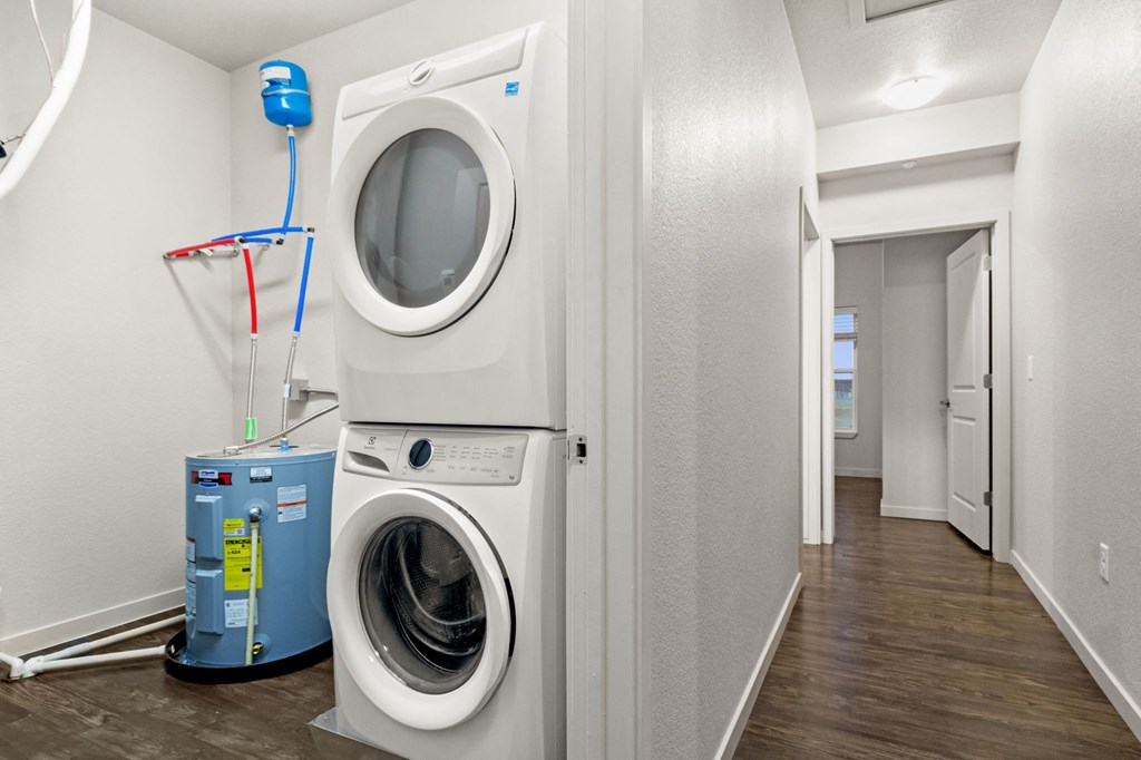 a white laundry room with a washing machine and a dryer