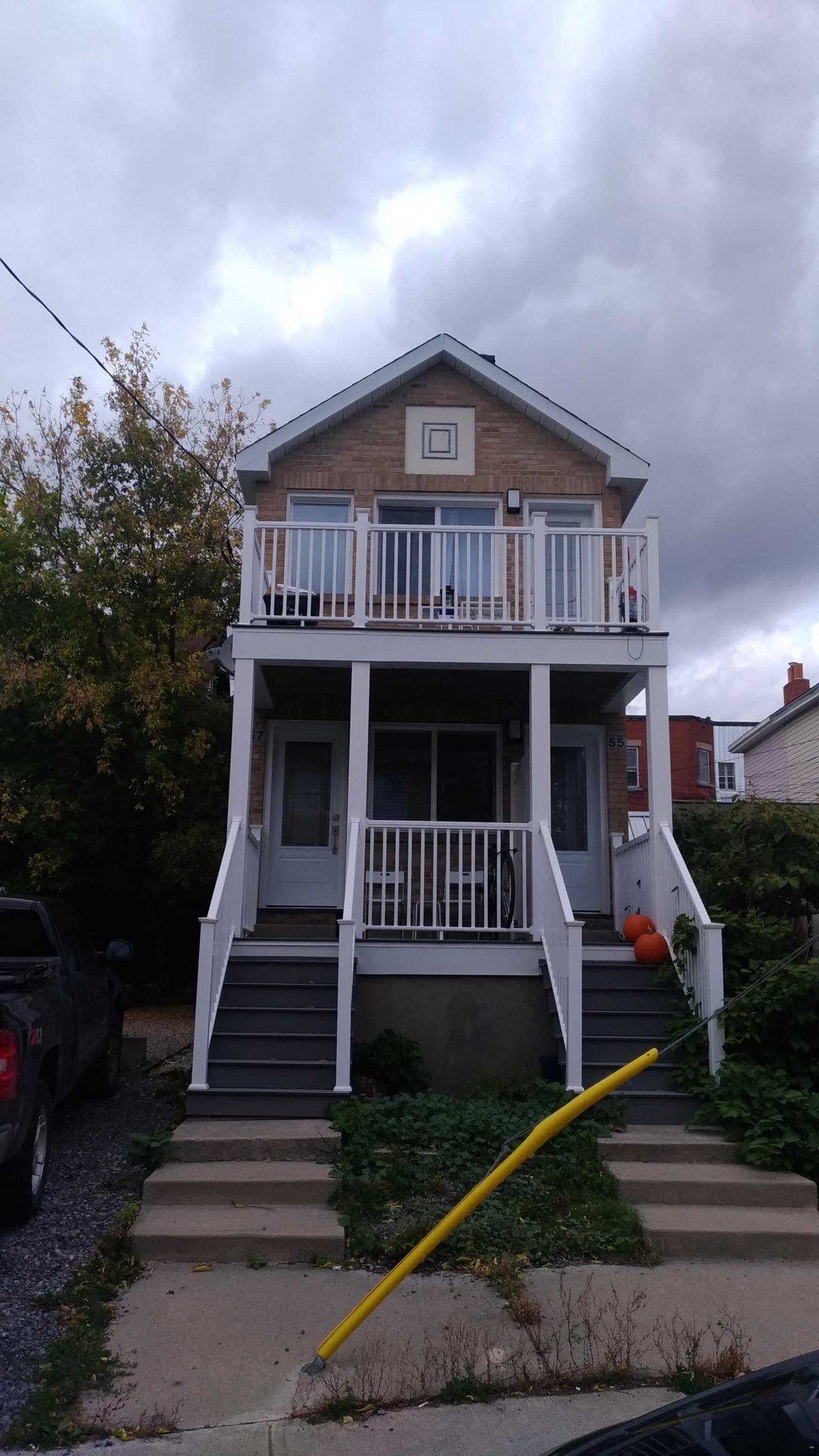 the front of a house with a yellow hose in front of it