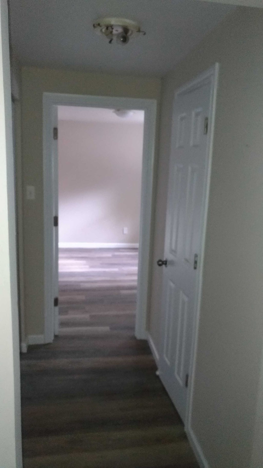 a view of a hallway with a door open to a room