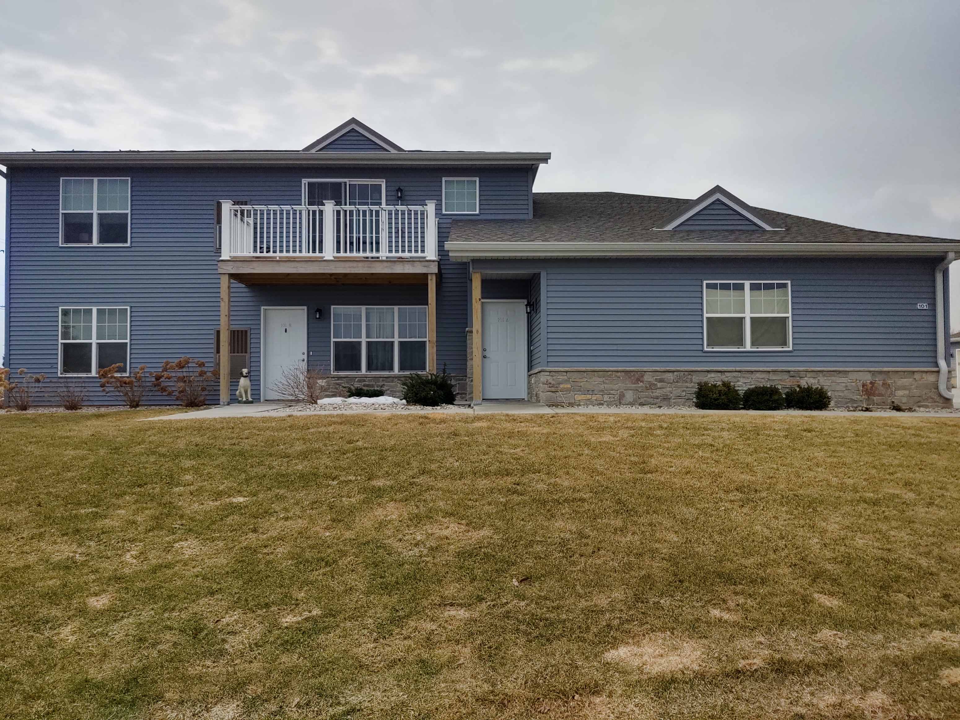 a blue house with a yard in front of it