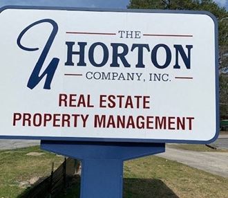 a sign for the horton company real estate property management
